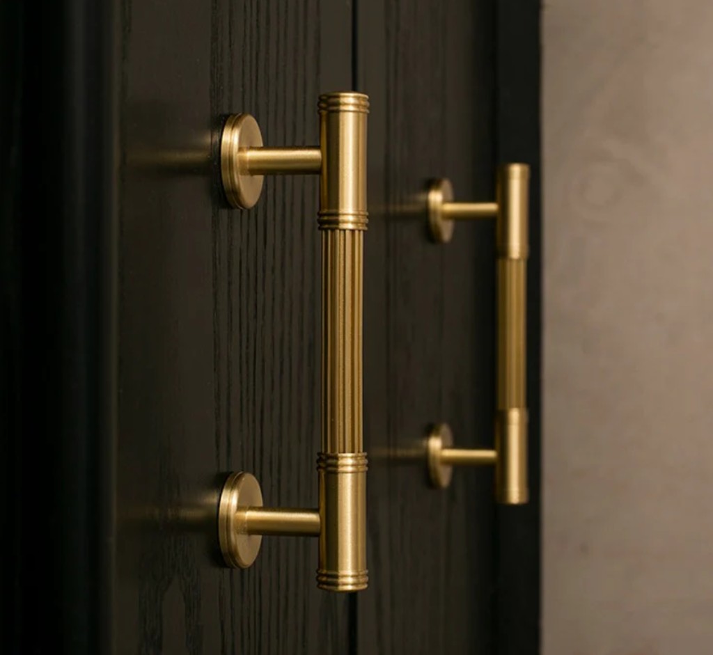 Brass-plated architectural door hardware on wood